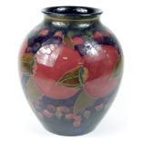 Moorcroft. A William Moorcroft pomegranate pattern baluster vase, circa early 20th Century, signed