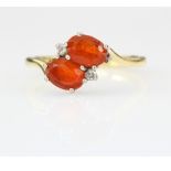18ct gold ring set with two fire opals and two very small diamonds. Size P 3.8g