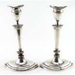 Pair of silver candlesticks with loaded bases (one sconce is a bit loose, and one of the sticks is a