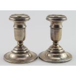 Two dwarf silver candlesticks, both with loaded bases, hallmarked Chester, 1918.