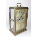 Large brass four glass mantel clock, circa 19th Century, with eight day movement, winged hourglass