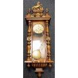 Clock, vintage wall mounted chiming pendulum clock, enamel dial with Roman numerals, gilded