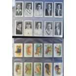 Trade cards, accumulation of cards contained in four albums, part sets & odds, various issuers