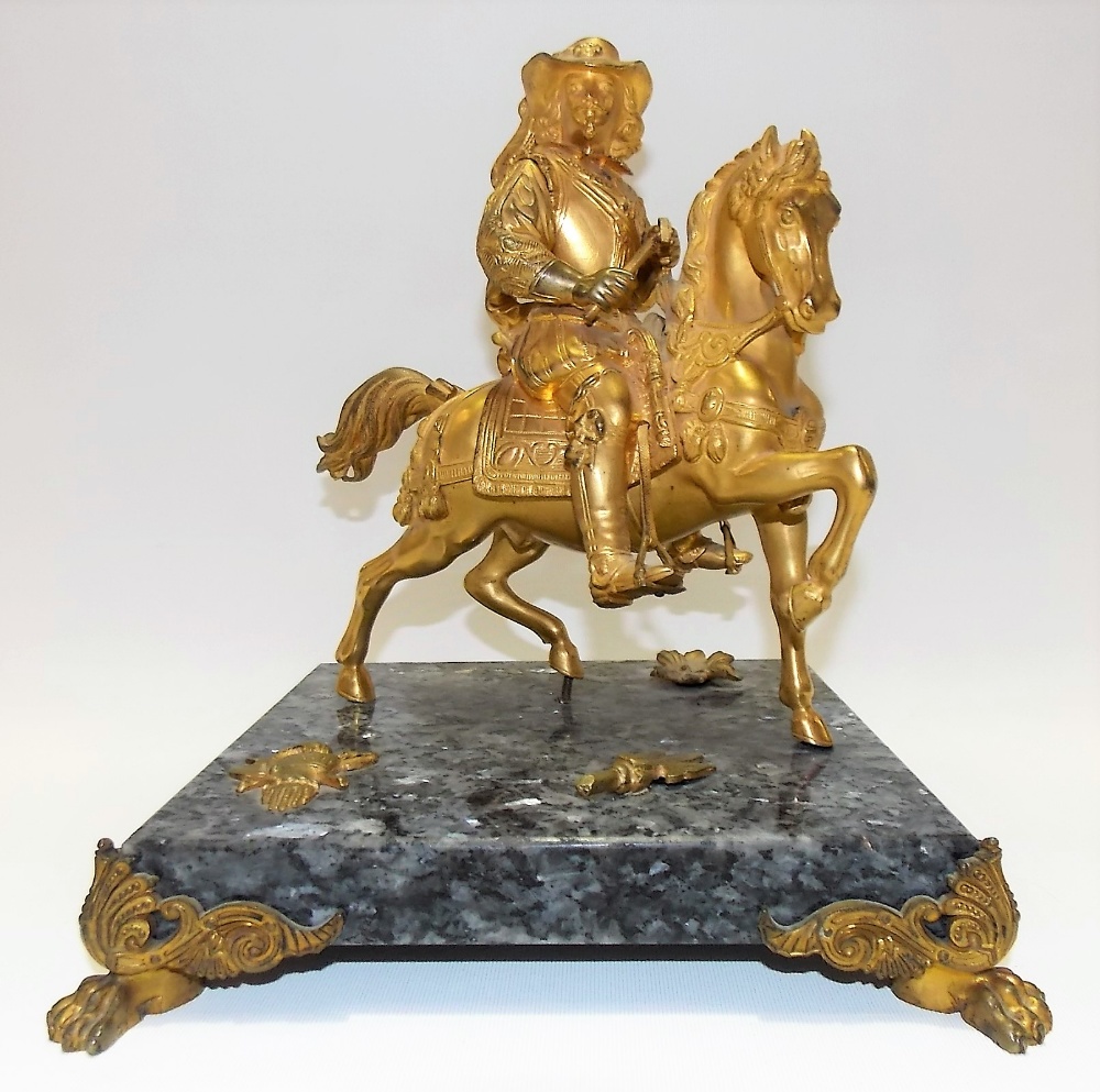 Gilt bronze group modelled as a gentleman in 17th Century dress on horseback upon a square grey