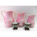 Set of 3 Victorian pottery relief moulded jugs; together with a pair of continental porcelain