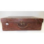 Vintage tan leather suitcase.