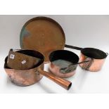 Three copper saucepans, a large copper saucepan lid with wrought iron handle and a copper preserve