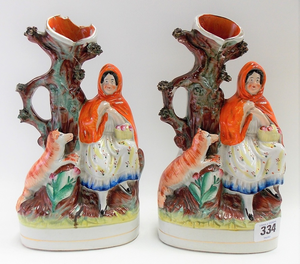 Two Staffordshire pottery spill vases modelled as Red Riding Hood, height 26cm (one with damages).