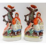 Two Staffordshire pottery spill vases modelled as Red Riding Hood, height 26cm (one with damages).