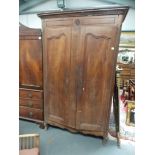 Early 19th Century French Provincial fruitwood armoire, the moulded edge cornice over a pair of