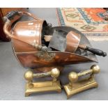 Copper coal helmet and scoop, together with a pair of brass fire dogs.