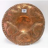 Arts and Crafts copper embossed circular dish decorated with five stylised fish amongst kelp,