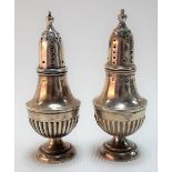 Pair of Victorian silver baluster pepper shakers with engraved crests, height 8.5cm, Birmingham
