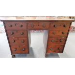 Victorian mahogany twin pedestal desk with an arrangement of nine drawers & raised on squat ball &