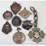 Six hallmarked silver watch fob medals together with a badge & a St. Christopher pendant, weight
