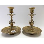 Pair of 19th Century brass foliate cast candlesticks with circular drip trays, height 19cm.