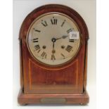 1920's mahogany inlaid three-train mantel clock, the arched case with 6 inch silvered dial with