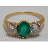Good early 20th Century 18ct gold emerald & diamond three stone ring, the oval central emerald of