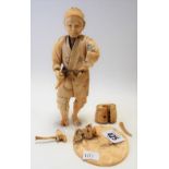 Meiji period Japanese ivory okimono, carved as gentleman holding a basket upon a circular stand,