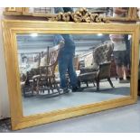 Large rectangular gilt framed wall mirror with gesso moulded ribbon surmount, the rectangular