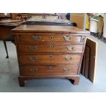George III mahogany bachelor chest, the hinged top over two slide supports & an arrangement of