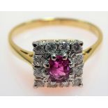 18ct hallmarked gold platinum set diamond and ruby cluster ring, the central ruby of 0.30ct spread