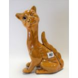 Watcombe Torquay pottery model of a stylised seated winking cat with glass inset eye, stamp mark