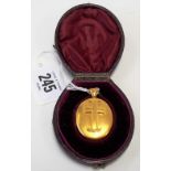Victorian high purity gold oval locket applied with a cross & within original Moroccan leather case,