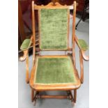 A folding rocker chair with upholstered back, elbows & seat