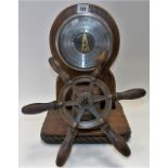 Unusual nautical oak aneroid barometer with ship's wheel, the base with rope border, height 39cm.