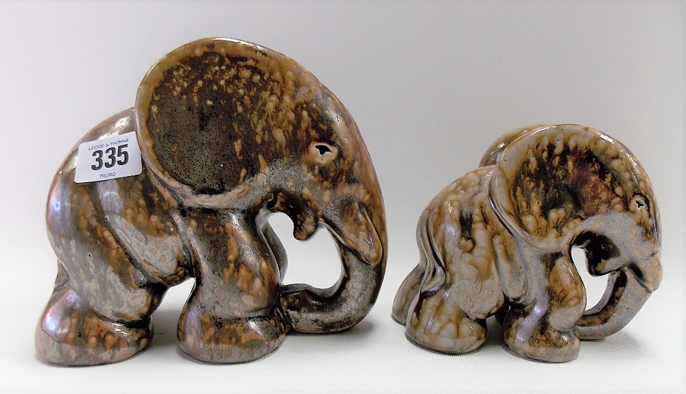 Pair of graduated Bako pottery stylised elephants with brown drip glaze, stamped BAKO to the base,