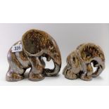 Pair of graduated Bako pottery stylised elephants with brown drip glaze, stamped BAKO to the base,