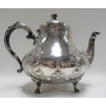 Victorian silver baluster teapot, foliate strapwork embossed and engraved, the domed lid with flower