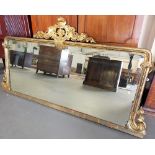 Victorian large gilt framed rectangular over mantel mirror, the gilt wooden gesso frame with foliate