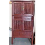 Oriental red painted floor standing cupboard with two cupboard doors over a sliding front