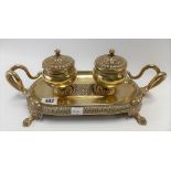 Victorian brass ink stand, of oval section with two hinge lidded ink pots, the stand with twin