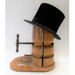 Milliner's hat stretcher, height 33cm; together with a moleskin top hat (2).