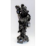 Chinese carved root figure of a sage carrying a branch with peach, with bone inset eyes and teeth,