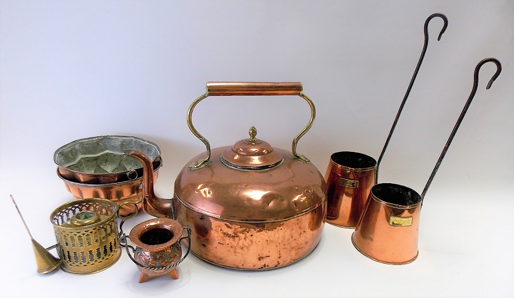 Seven copper and brass items, to include two jelly moulds, a large copper and brass kettle, two