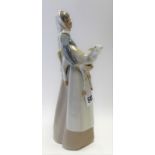 Lladro porcelain model of a shepherdess with lamb in her arms, height 28cm.