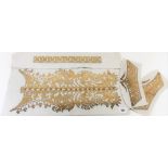 Gold metal thread embroidered apron cuff and collar panels.