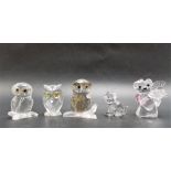 Three small Swarovski crystal owls; together with a Swarovski crystal geisha, bear and cat (5).