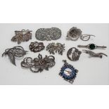 Ten various silver and white metal brooches.