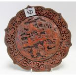Chinese cinnabar lacquer dish decorated in relief with figures in a pagoda landscape and with shaped
