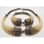 White metal mounted boar's tusk necklace and matching bangle, the terminals applied with acorns