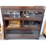 Oak low bookcase with three glazed sliding doors, width 123cm