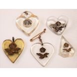 Four early 20th Century heart-shaped celluloid & metal mounted sweetheart pendant brooches & one