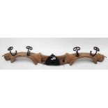 Pine and wrought iron double yoke converted to a wall hanging coat rack, length 122cm.