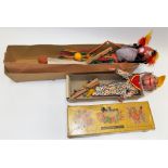 Two boxed Pelham puppets, one a Hawaiian dancer, the other a standard clown puppet.