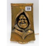 Brass wall plaque cast as the head of a jovial monk, height 21cm.